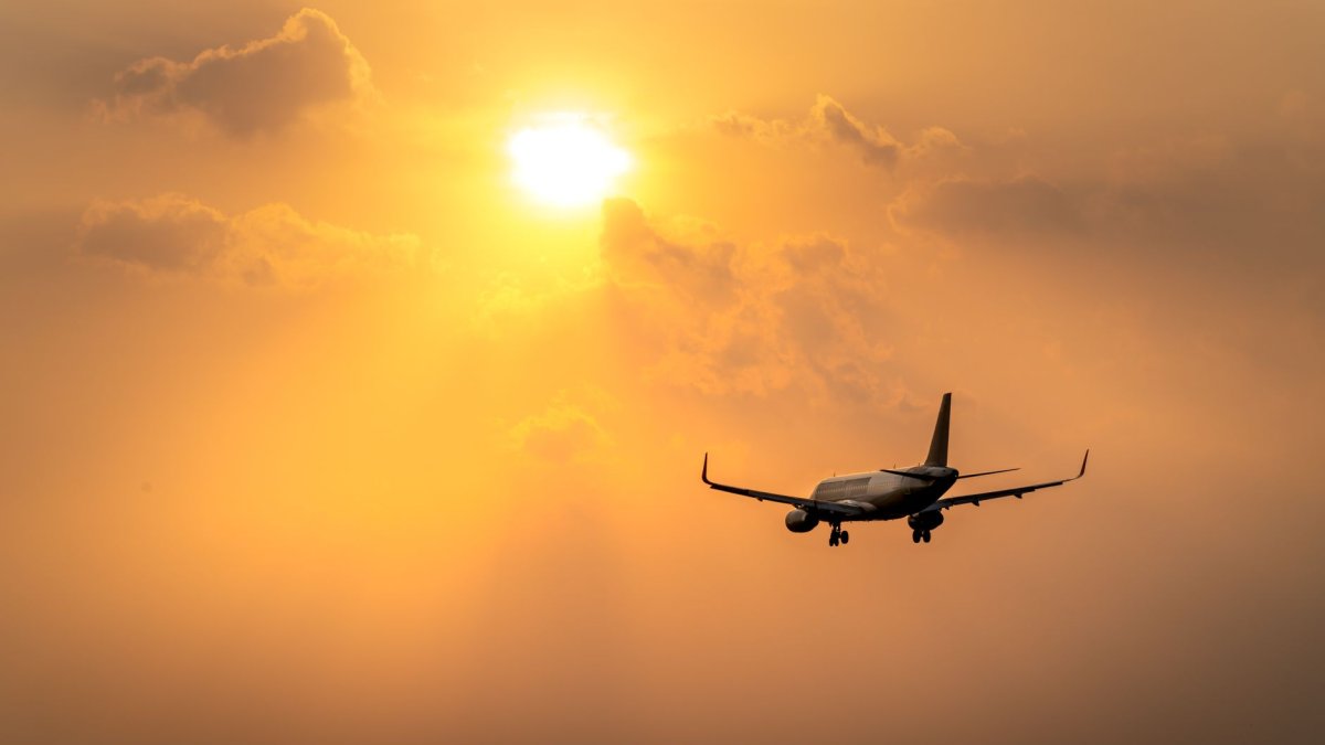 airplane landing at sunset