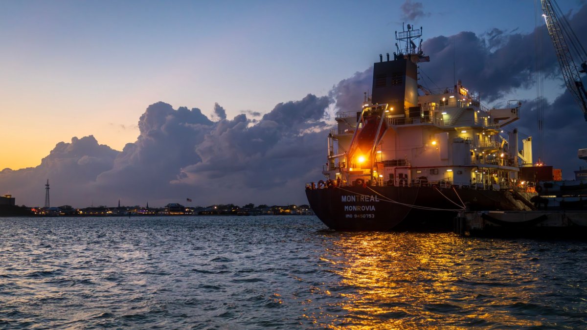 ship leaving harbor sunset